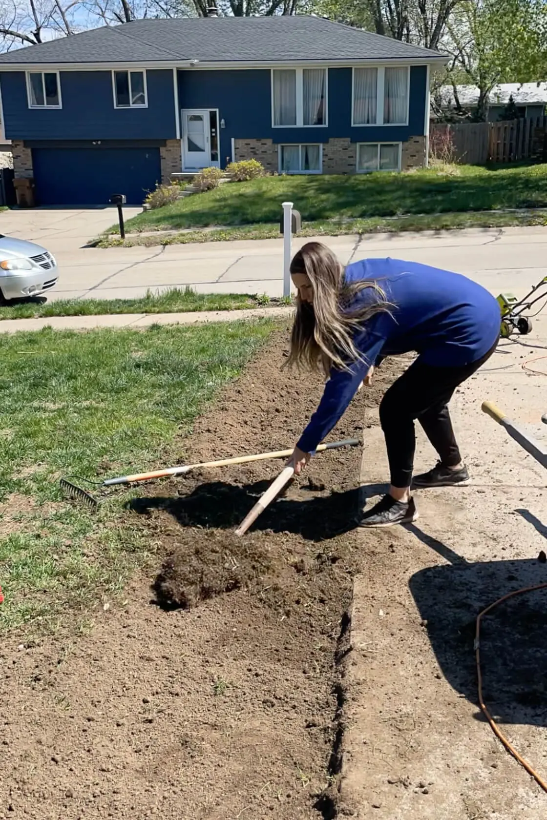 Removing dirt to make way for a paver driveway extension.